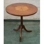 A mahogany occasional table with inlaid top and tripod base.