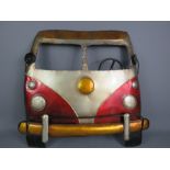 A tin painted Volkswagen camper van front.