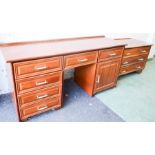 A mahogany chest of drawers on wheels together with a sideboard.