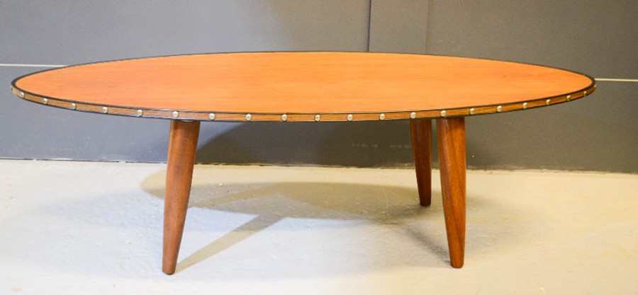 An oval teak mid-century coffee table.