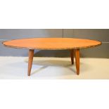 An oval teak mid-century coffee table.