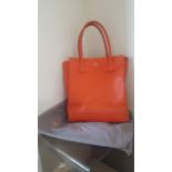 A Mulberry orange leather tote bag, with original dust cover in grey.