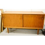 A 1950s teak sideboard with two sliding doors.
