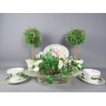 A group of miscellaneous to include model lollipop trees, pair of cups and saucers, flowers in glass