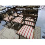 A mahogany dining table and set of chairs.