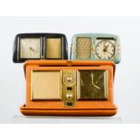A travelling alarm clock together with two retro bakelite alarm clocks.