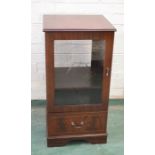 A modern mahogany music cabinet with glass door.