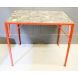 A marble top table, with industrial red iron base.