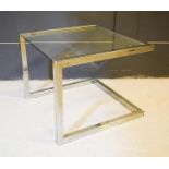 A glass top side table with chrome base.