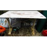 A cast iron garden table with wooden rectangular top, painted white.