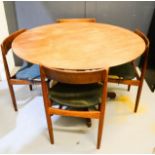 A 1950s teak table and four matching chairs.