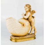 A porcelain cherub form spoon warmer.