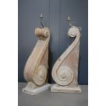 A pair of limed oak corbels converted into lamp bases, with cream silk shades, 82cm high.