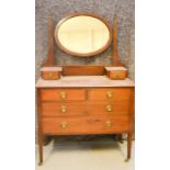 An Edwardian dressing table with oval mirrored back.