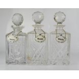 Three decanters, with ceramic label tags; Brandy, Whisky, Sherry.