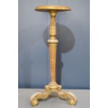 A 19th century Italian gilt wood and composition torchere, with a reeded column and scrolling tripod