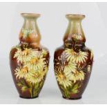 A pair of Doulton Lambeth daisy pattern vases.