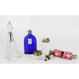 A group of Victorian perfume bottles and a small dressing table pot with silver lid and Eau de