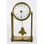A French brass mantle clock, with porcelain arabic dial, raised on columns with pendulum, 22cm