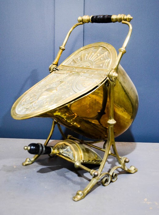 An Adam style Victorian brass helmet form coal scuttle and shovel, with brass and ebony handle.