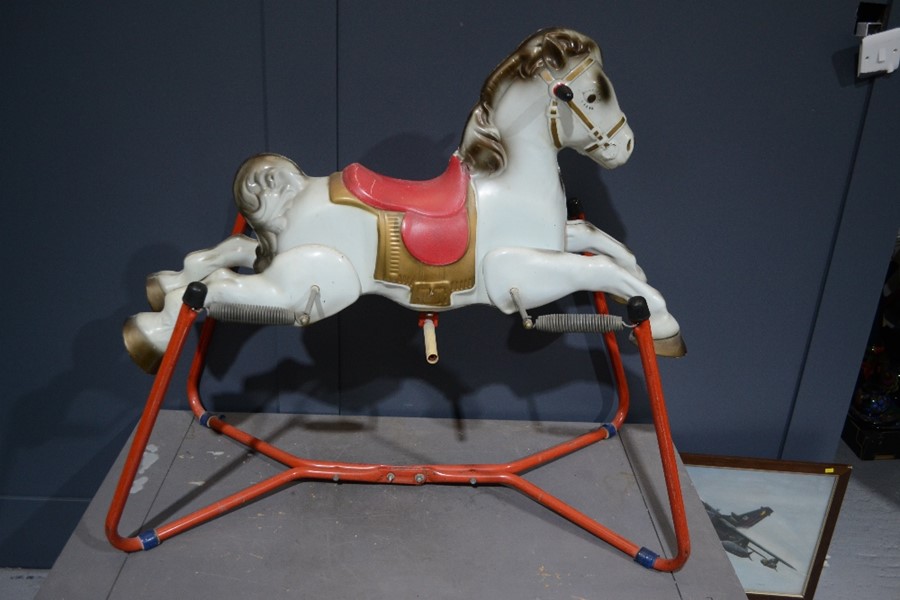 A 1950s tin horse on spring base.