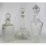Three glass decanters, one cut crystal example 31cm high.