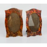 A pair of faux tortoiseshell picture frames.