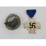A German medal and award badge depicting a naval vessel.
