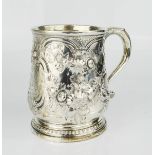 A silver tankard embossed with floral scrollwork, gilt interior with presentation inscription