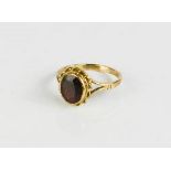 A 9ct gold and garnet ring, size S, 3.5g.