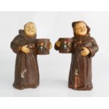 A pair of candlesticks in the form of monks.
