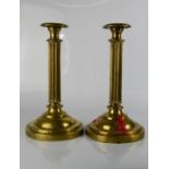 A pair of brass early 19th century candlesticks in the form of fluted columns.