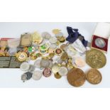 A box of cap badges and medals.
