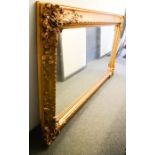 A large reproduction gilt carved mirror, 7ft 1" by 4ft 2".