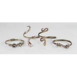 Two silver snake form bangles, two rams head bangles.