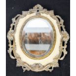 An antique mirror with scrollwork border, 32cm high.