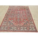 A Middle Eastern rug with red and blue pattern, 227 by 316cm