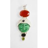 A silver and malachite pendant, in the form of a face.