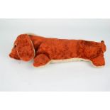 An early 20th century toy sausage dog.