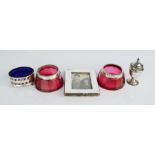 A silver photograph frame, two cranberry and silver rim glass salts, blue lined glass salt and