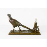 A bronzed candle holder in the form of a pheasant.