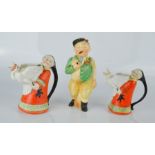 A pair of comical jugs in the form of Chinese figures with cranes, tallest 12cm high, together