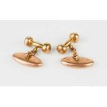 A pair of 9ct rose gold cuff links, torpedo and dumbbell shaped on chain fittings, 7.8g.