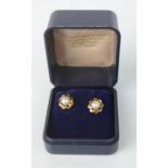 A pair of yellow metal and pearl stud earrings.