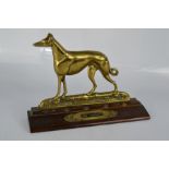 A brass ornament / door stop titled The Greyhound, 20cm high.