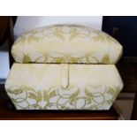 A small yellow upholstered ottoman.