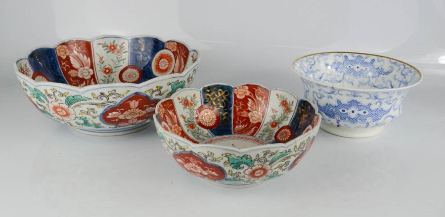 Two imari bowls, together with a blue and white Chinese bowl with character marks to the base.