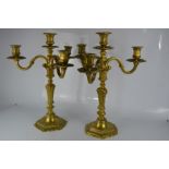 A pair of 18th century candelabra in gilt bronze, each having three branches.