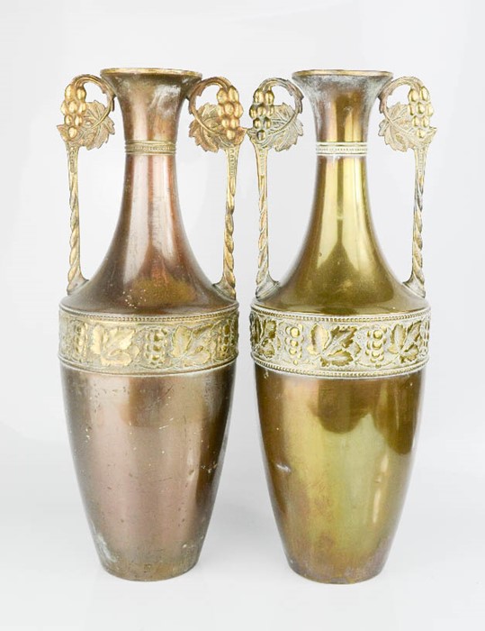 A pair of brass vases / urns with twin handles.