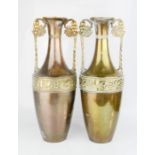 A pair of brass vases / urns with twin handles.